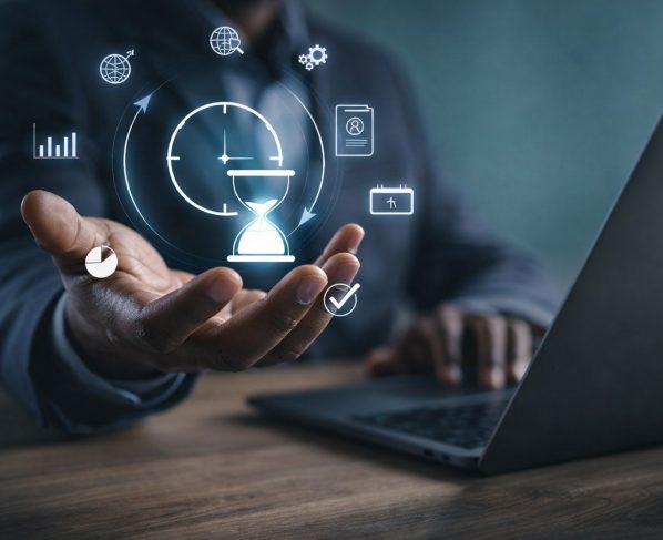 Black professional using a laptop with digital time management and productivity icons floating above hand